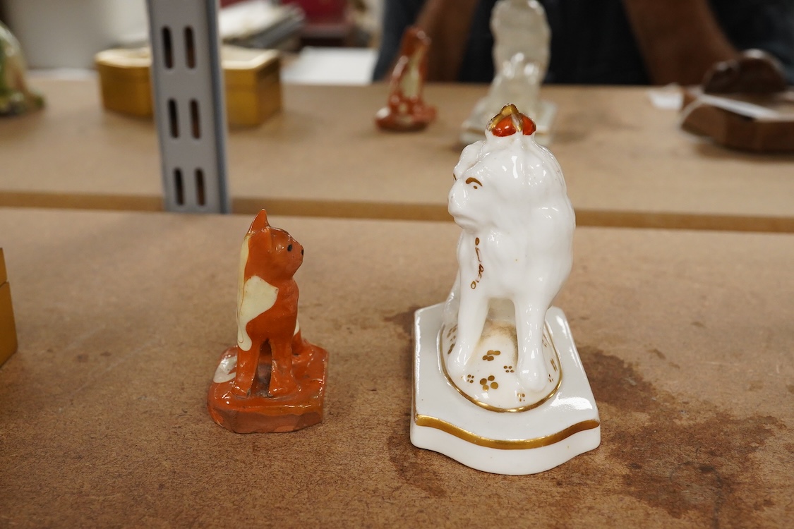 A Staffordshire lion with crown, c.1830-50 and a Staffordshire slipware cat, largest 8.5cm high (2)